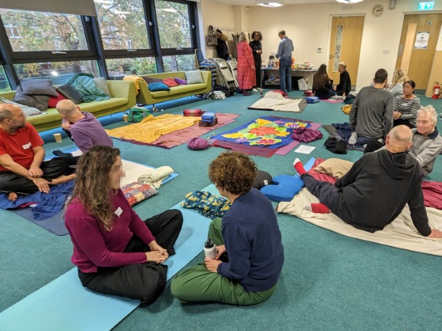 People chatting in pairs on the floor deeply relaxed