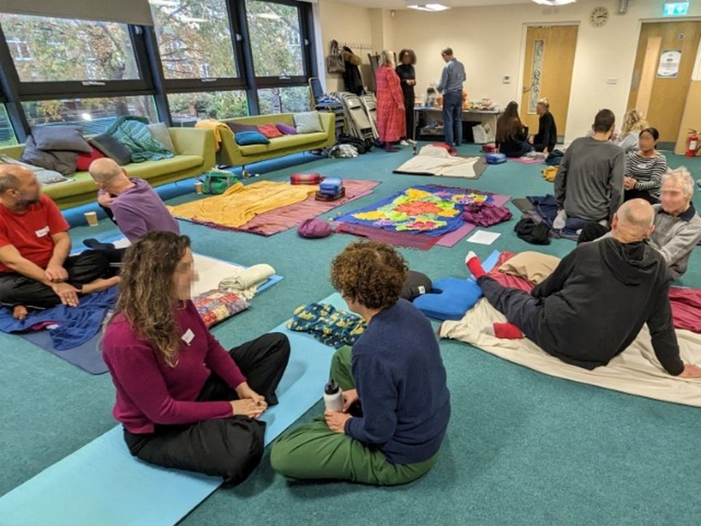 People sitting on the floor chatting warmly