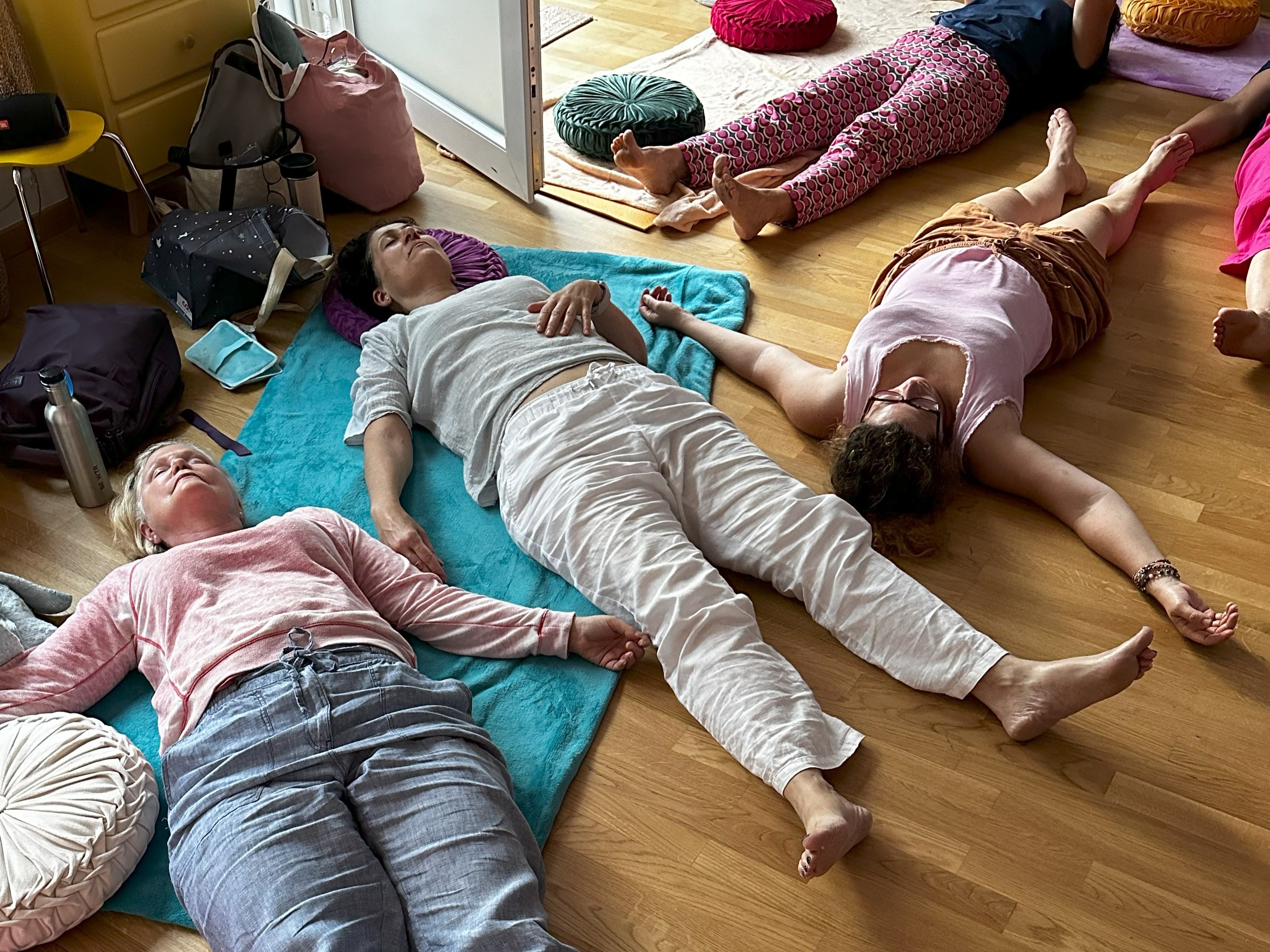 People lying on the floor deeply relaxed